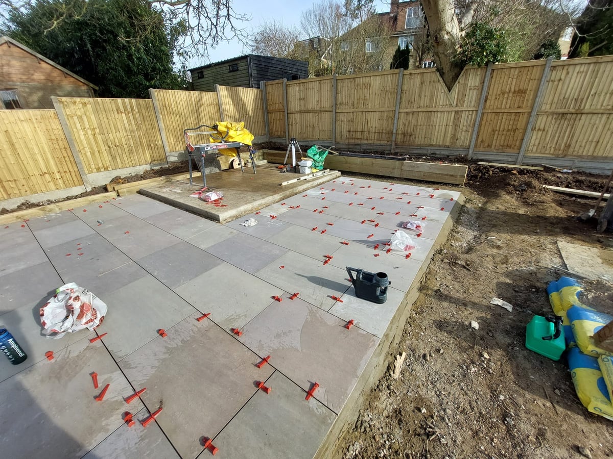 Patio installation area bordered by new timber fencing