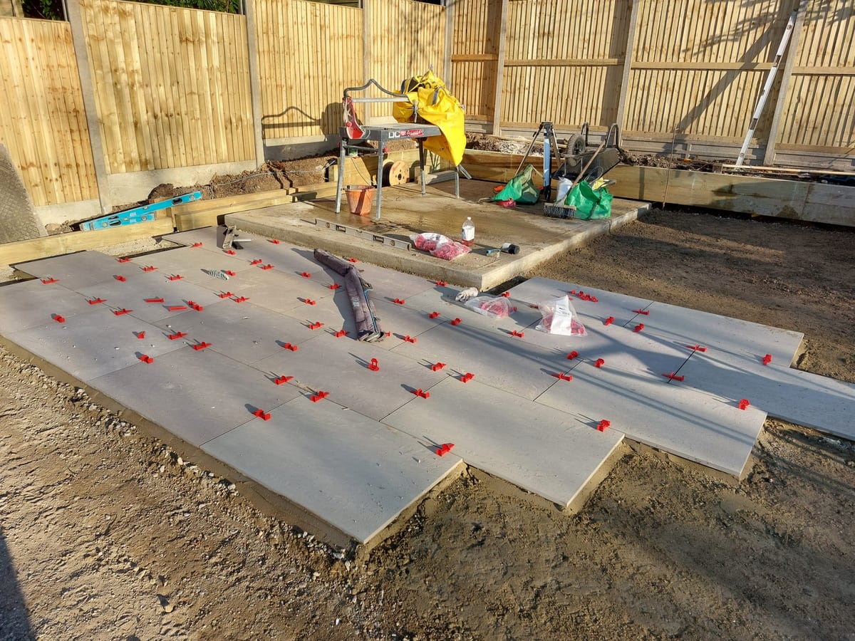 Patio slabs being laid with levelling spacers during installation