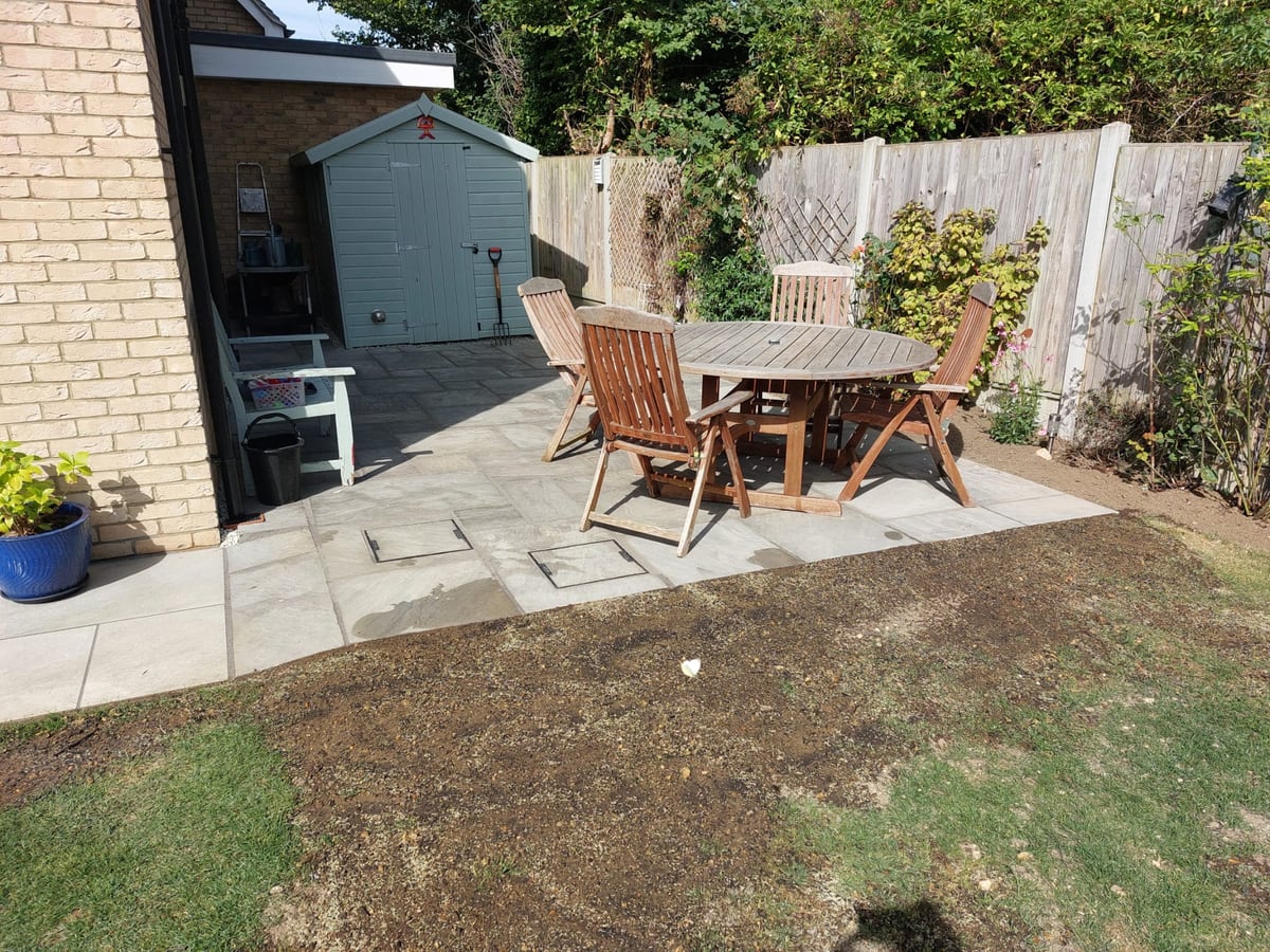 Finished patio area around a garden room with gravel edging
