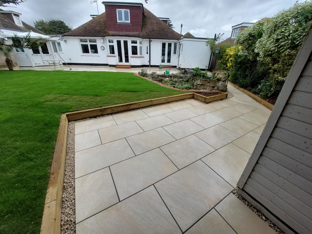 Finished patio path leading through a landscaped back garden